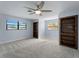Bedroom with two built-in bookshelves, light blue walls, and a ceiling fan at 318 Oakwood Cir, Englewood, FL 34223
