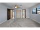 Bedroom with three entrances, two closets, light blue walls, and a ceiling fan at 318 Oakwood Cir, Englewood, FL 34223