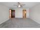 Bright and airy bedroom featuring plush carpet, a ceiling fan, and convenient access to ensuite bathroom at 318 Oakwood Cir, Englewood, FL 34223