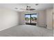 Expansive bedroom featuring plush carpeting, ceiling fan, and sliding glass doors to a large private balcony at 318 Oakwood Cir, Englewood, FL 34223