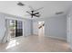 Bright and spacious bedroom features tile floors, ceiling fan, and large window for natural light at 318 Oakwood Cir, Englewood, FL 34223