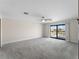 Spacious bedroom featuring plush carpeting, a ceiling fan, and sliding glass doors to a private balcony at 318 Oakwood Cir, Englewood, FL 34223