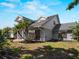 View of the home's facade with landscaped garden, manicured lawn and mulched flower beds at 318 Oakwood Cir, Englewood, FL 34223