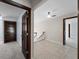 Hallway view with tile flooring and a staircase to the second floor at 318 Oakwood Cir, Englewood, FL 34223