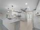 Bright and airy kitchen with white cabinetry, quartz countertops, and modern appliances at 318 Oakwood Cir, Englewood, FL 34223