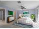 Cozy main bedroom with a blue accent rug, stylish dresser, and ample natural light at 318 Oakwood Cir, Englewood, FL 34223