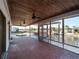 Spacious screened-in patio with brick flooring and ceiling fans offers stunning waterfront views of the canal at 318 Oakwood Cir, Englewood, FL 34223