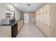 Utility room featuring a sink, dishwasher, and ample cabinet storage for organization at 318 Oakwood Cir, Englewood, FL 34223