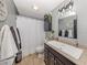 Bathroom with elegant vanity, decorative mirror and storage at 3255 Tally Ho Rd # 1, North Port, FL 34291