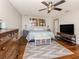This primary bedroom features a ceiling fan, hardwood floors and large bed at 3255 Tally Ho Rd # 1, North Port, FL 34291