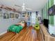 This sports themed bedroom features wood floors and a ceiling fan at 3255 Tally Ho Rd # 1, North Port, FL 34291