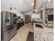 Well-lit kitchen with stainless steel fridge, modern appliances, and granite countertops at 3255 Tally Ho Rd # 1, North Port, FL 34291