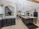 Charming kitchen with dark cabinetry, granite countertops, and views of the living space at 3255 Tally Ho Rd # 1, North Port, FL 34291