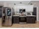 Close up of kitchen with stainless appliances, white cabinets, and breakfast bar at 3255 Tally Ho Rd # 1, North Port, FL 34291