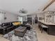 Comfortable living room featuring a large sectional sofa, windmill ceiling fan and neutral tones at 3255 Tally Ho Rd # 1, North Port, FL 34291