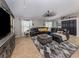 Spacious living room with a comfortable sectional sofa, stylish rug, and a decorative ceiling fan at 3255 Tally Ho Rd # 1, North Port, FL 34291