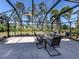 This patio has black metal screening, and glass top table with seating for six at 3255 Tally Ho Rd # 1, North Port, FL 34291
