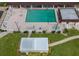 Aerial view of community pool area, including a pool, hot tub, and sun loungers at 3255 Tally Ho Rd # 1, North Port, FL 34291