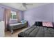 Bedroom with two comfortable twin beds, ceiling fan, and neutral walls, offering a clean and comfortable space at 3870 Log Cabin Rd, North Port, FL 34291
