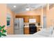 Well-lit kitchen with stainless steel appliances, laminate counters, and abundant cabinet space at 3870 Log Cabin Rd, North Port, FL 34291