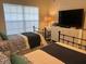Shared bedroom featuring two twin beds and a large television at 406 Laurel Lake Dr # 103, Venice, FL 34292