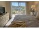 Bright bedroom offering serene water views and a queen bed at 406 Laurel Lake Dr # 103, Venice, FL 34292