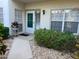 Inviting front entrance with a decorative planter, manicured landscaping, and a well-lit doorway at 406 Laurel Lake Dr # 103, Venice, FL 34292