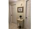 Hallway area with doors and a small table with decorative items at 406 Laurel Lake Dr # 103, Venice, FL 34292