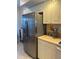 Modern stainless steel refrigerator complemented by white cabinets and countertops at 406 Laurel Lake Dr # 103, Venice, FL 34292