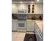 Well-maintained kitchen featuring white appliances, ample counter space, and plentiful cabinet storage at 406 Laurel Lake Dr # 103, Venice, FL 34292