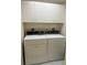 Bright laundry area features washer, dryer, and upper cabinets at 406 Laurel Lake Dr # 103, Venice, FL 34292
