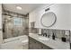 Bathroom featuring a granite vanity top and a shower over the tub at 421 Blackburn Rd, Nokomis, FL 34275
