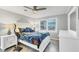 Bright bedroom with a peacock themed bed, fan, and bright daylight at 421 Blackburn Rd, Nokomis, FL 34275