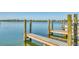 Private dock extends into serene water with community views, offering a perfect spot for relaxation or water activities at 421 Blackburn Rd, Nokomis, FL 34275