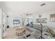 Inviting living room with neutral tile floors, a modern ceiling fan, and an open view of the kitchen at 421 Blackburn Rd, Nokomis, FL 34275