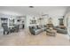 Open-concept living space that flows into the dining area, featuring neutral tile and contemporary furnishings at 421 Blackburn Rd, Nokomis, FL 34275