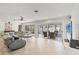 Spacious living room with neutral tile, modern fan, and sliding glass doors that enhance natural light and views at 421 Blackburn Rd, Nokomis, FL 34275