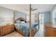 Serene main bedroom with a four-poster bed, ceiling fan, and an en-suite bathroom at 421 Blackburn Rd, Nokomis, FL 34275