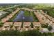 Aerial view of a lovely community with a lake, mature trees, and well-maintained landscaping at 4213 Vicenza Dr # A2, Venice, FL 34293