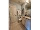 Bathroom features vanity with granite counter, nautical themed decor, and tile floor at 4213 Vicenza Dr # A2, Venice, FL 34293