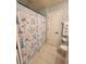 Bright bathroom with a marine themed shower curtain and white tiled floors at 4213 Vicenza Dr # A2, Venice, FL 34293