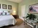 Comfortable bedroom with accent lighting, artwork and calming green walls at 4213 Vicenza Dr # A2, Venice, FL 34293