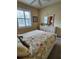 Bedroom with bright window, white dresser, and floral bedspread at 4213 Vicenza Dr # A2, Venice, FL 34293