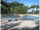 Inviting community pool and hot tub featuring lush landscaping and tranquil waterfall at 4213 Vicenza Dr # A2, Venice, FL 34293