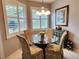 Inviting dining area with plantation shutters, a glass table and upholstered chairs at 4213 Vicenza Dr # A2, Venice, FL 34293