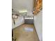 Empty one car garage with painted block walls, speckled epoxy floor and overhead shelving at 4213 Vicenza Dr # A2, Venice, FL 34293