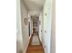 Hallway featuring wood floors and bright walls, leading to kitchen at 4213 Vicenza Dr # A2, Venice, FL 34293
