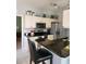 Well-lit kitchen featuring modern appliances, granite counters and breakfast bar with seating at 4213 Vicenza Dr # A2, Venice, FL 34293