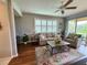 Bright living room featuring plantation shutters, neutral tones, and access to a screened lanai at 4213 Vicenza Dr # A2, Venice, FL 34293