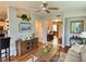 Cozy living room featuring a ceiling fan, hardwood floors, and stylish furnishings at 4213 Vicenza Dr # A2, Venice, FL 34293